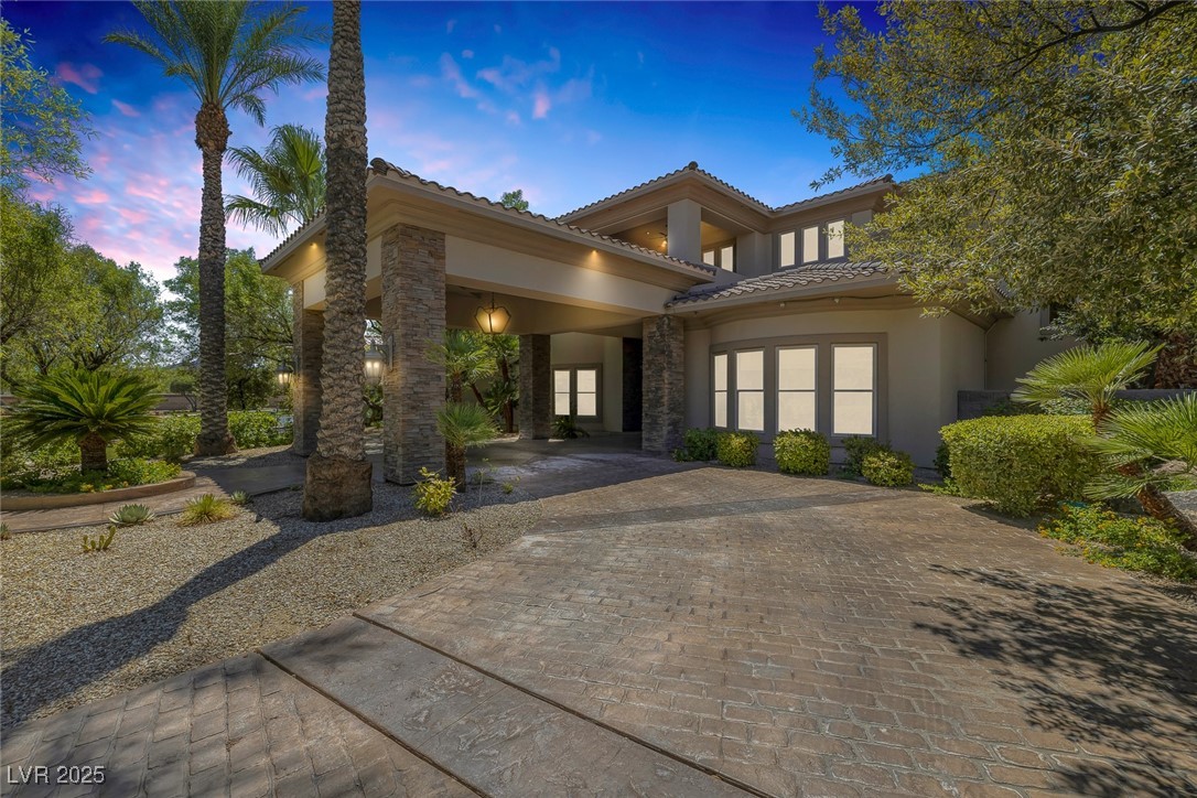 1545 Villa Rica Drive Henderson, NV 89052 - Photo 4 of 61 Doorway to property with stone siding, stucco siding, decorative driveway, and a tiled roof