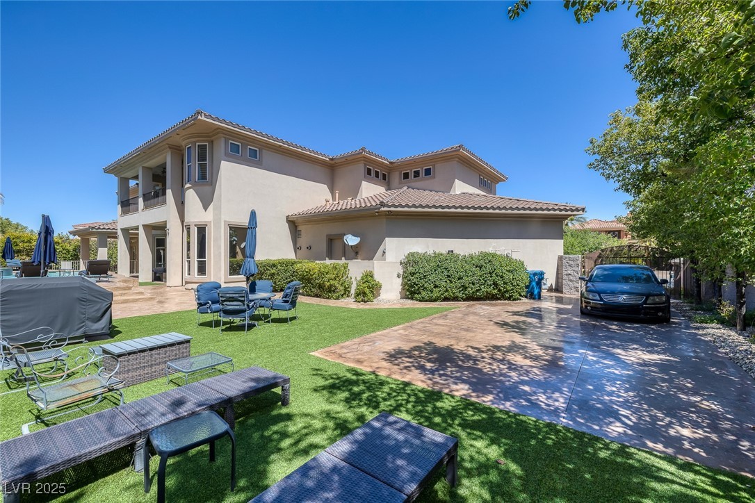 1545 Villa Rica Drive Henderson, NV 89052 - Photo 46 of 61 Back of property with a balcony, stucco siding, a tiled roof, and a patio