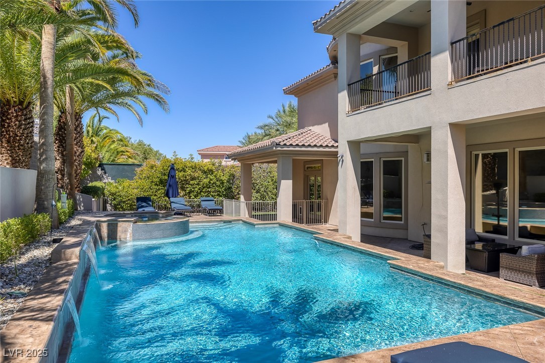 1545 Villa Rica Drive Henderson, NV 89052 - Photo 47 of 61 View of swimming pool with a patio area, a pool with connected hot tub, and an outdoor hangout area