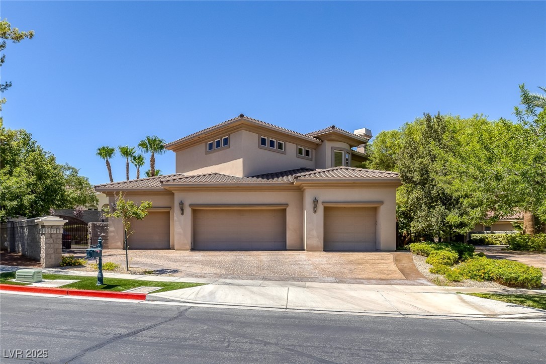 1545 Villa Rica Drive Henderson, NV 89052 - Photo 54 of 61 Mediterranean / spanish-style home featuring decorative driveway, an attached garage, stucco siding, and a tiled roof