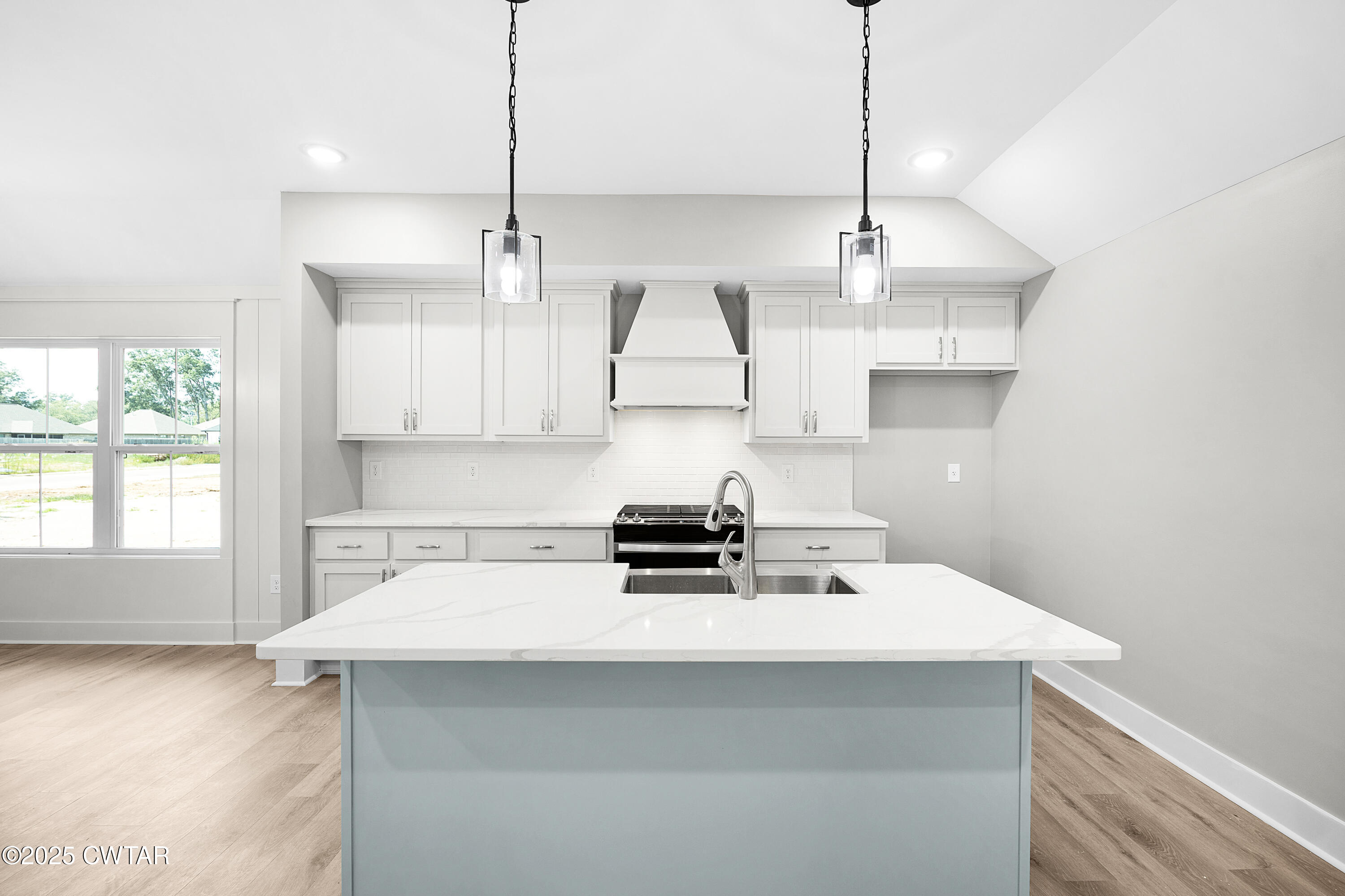36 Grande Pnes Cove Jackson, TN 38305 - Photo 11 of 23 a kitchen with a stove a sink a window and cabinets