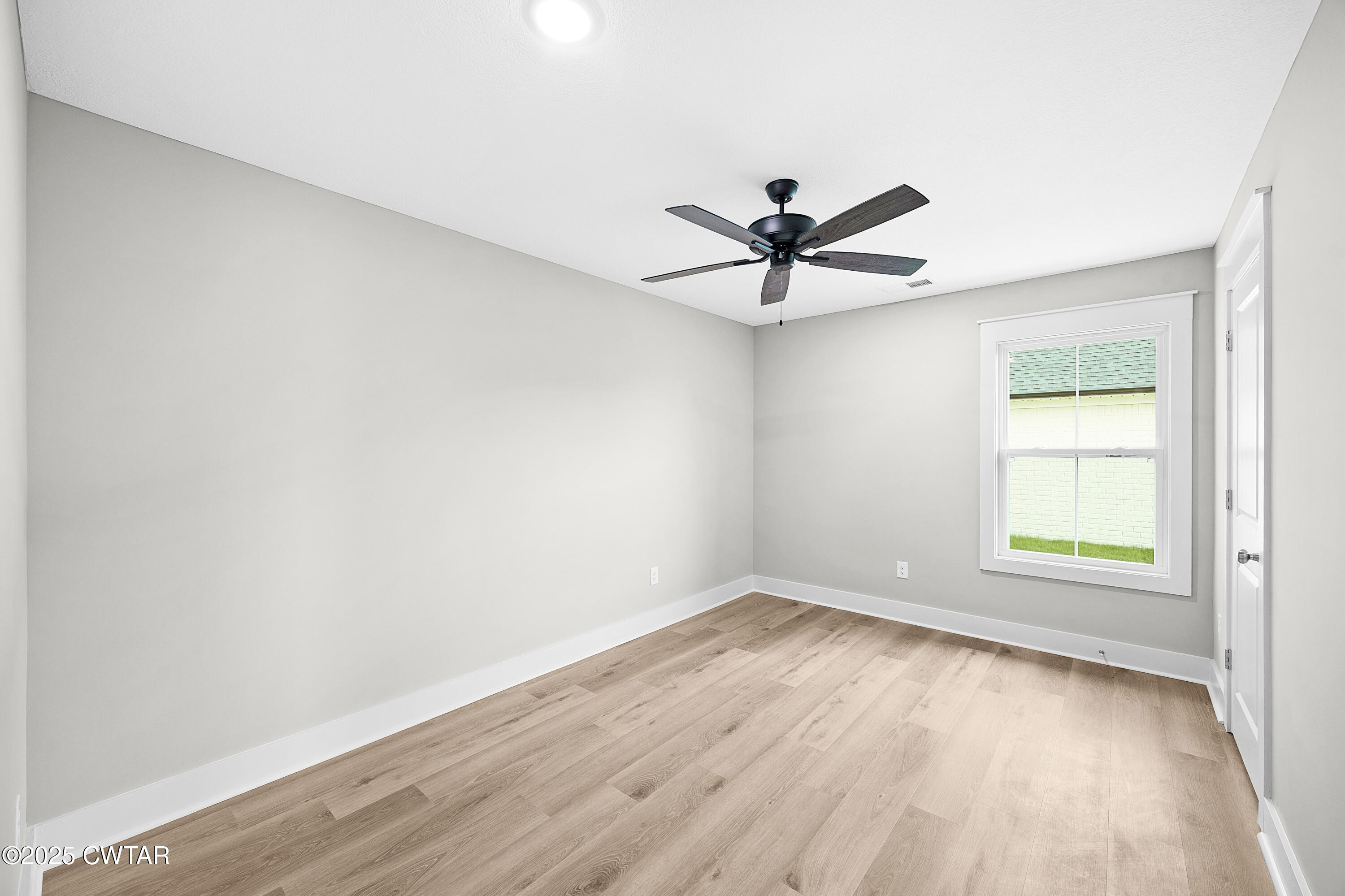 36 Grande Pnes Cove Jackson, TN 38305 - Photo 18 of 23 an empty room with wooden floor and windows