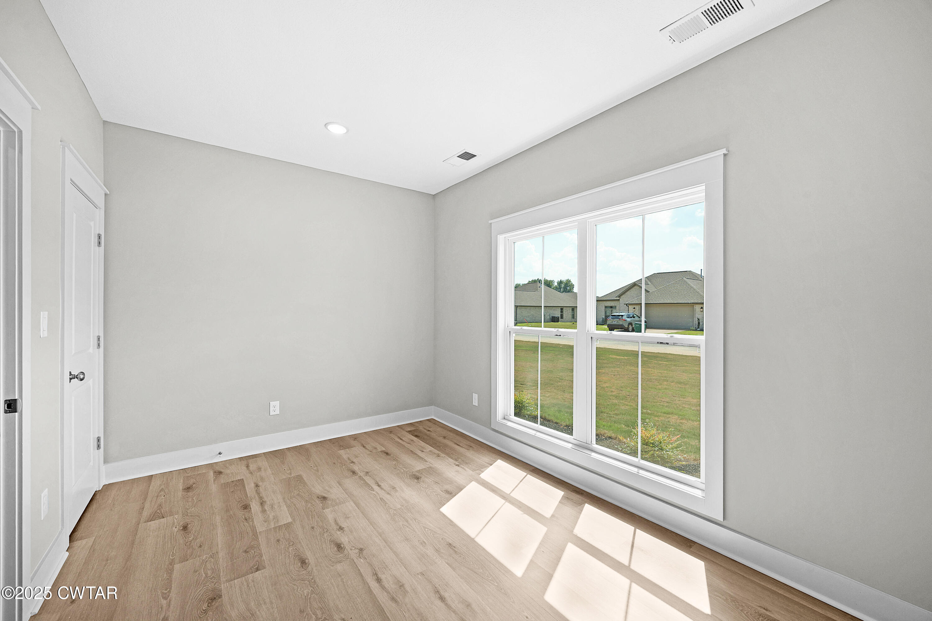 36 Grande Pnes Cove Jackson, TN 38305 - Photo 19 of 23 an empty room with wooden floor and a window