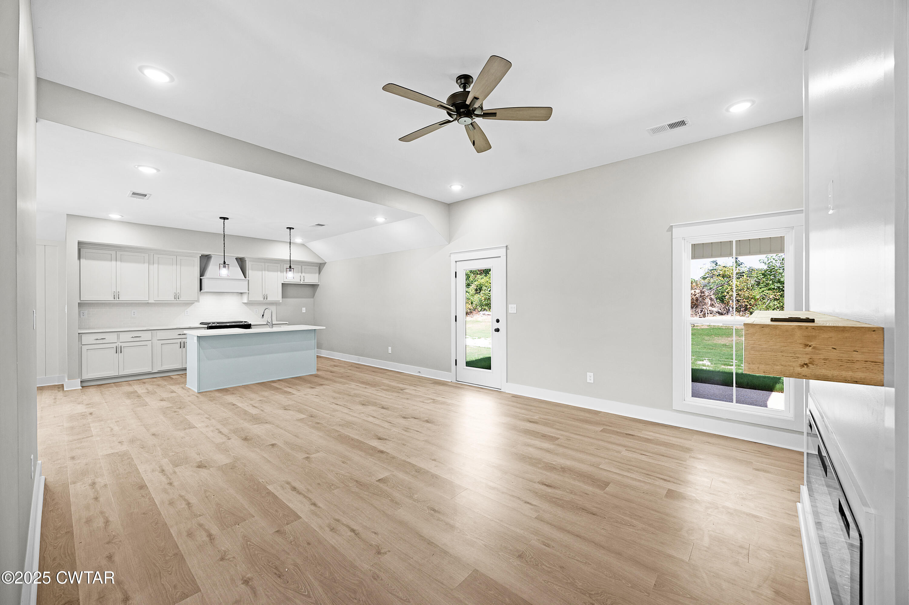 36 Grande Pnes Cove Jackson, TN 38305 - Photo 2 of 23 a view of a kitchen with a stove cabinets and wooden floor