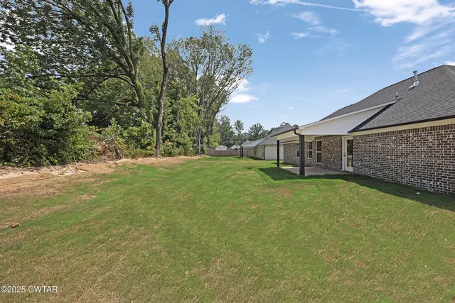 a backyard of a house with lots of green space