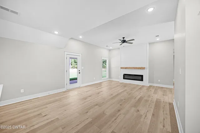 a view of an empty room with a fireplace