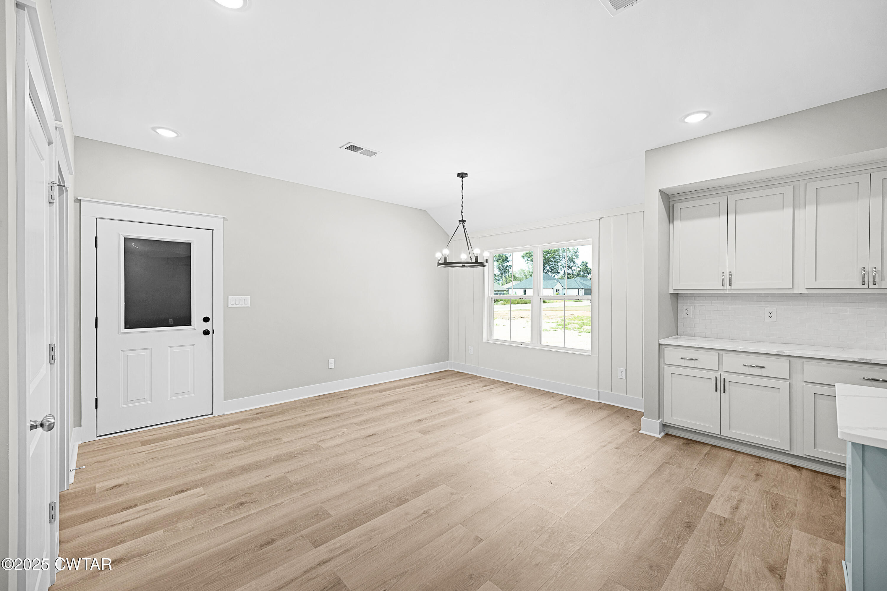 36 Grande Pnes Cove Jackson, TN 38305 - Photo 6 of 23 a view of an empty room with window and wooden floor