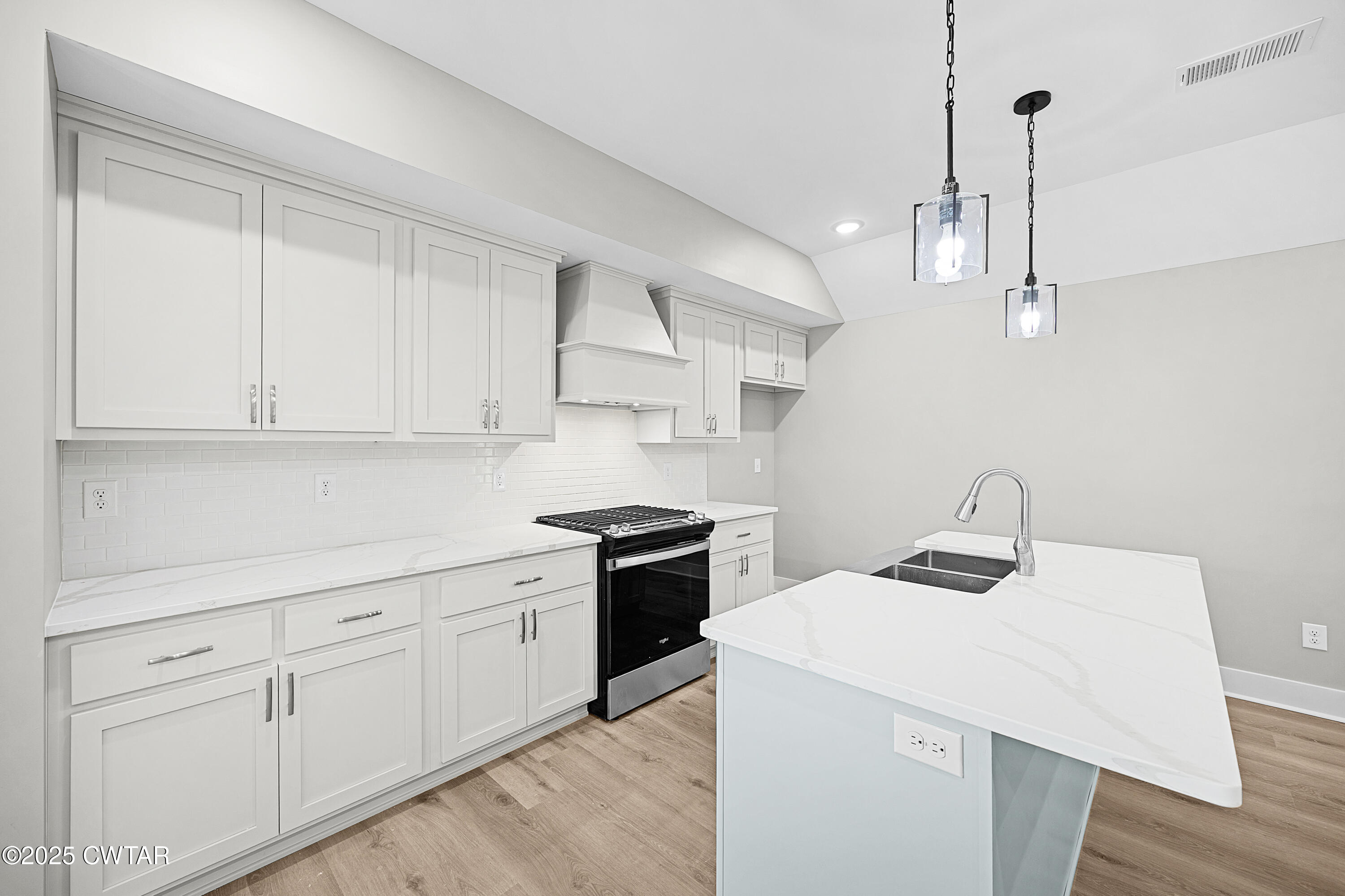 36 Grande Pnes Cove Jackson, TN 38305 - Photo 8 of 23 a kitchen with a sink dishwasher and white cabinets with wooden floor