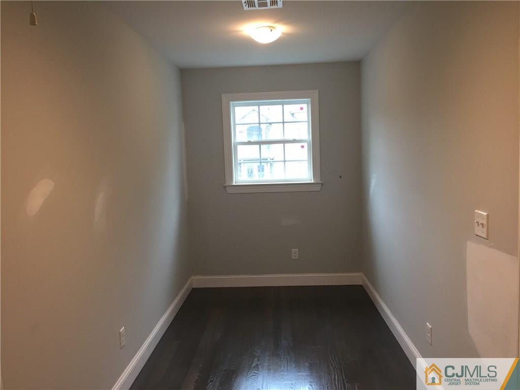 140 Dover Road Colonia, NJ 07067 - Photo 14 of 14 an empty room with wooden floor and windows