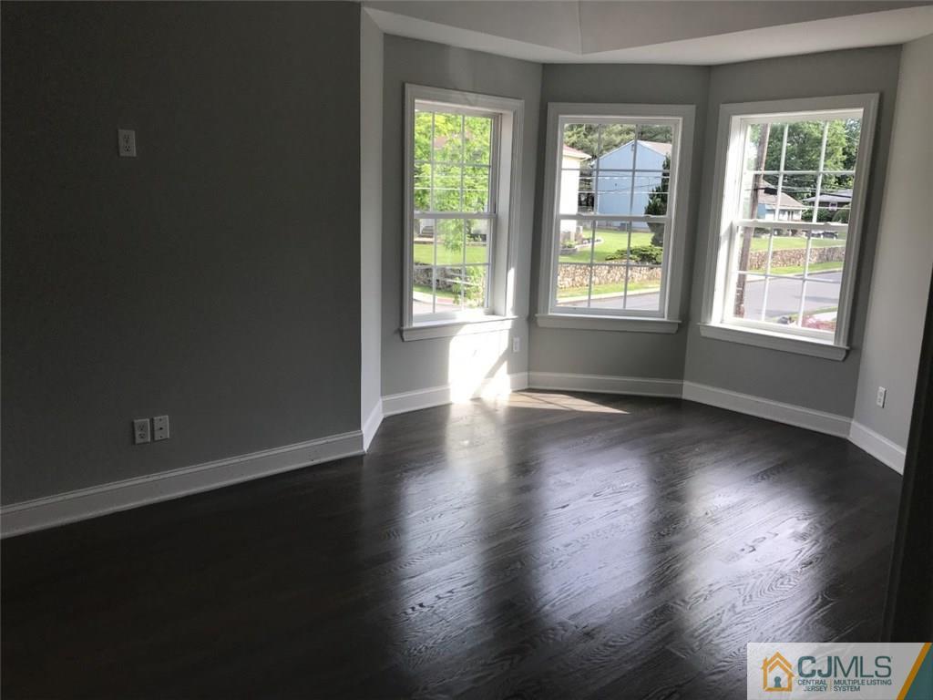 140 Dover Road Colonia, NJ 07067 - Photo 4 of 14 an empty room with wooden floor and windows