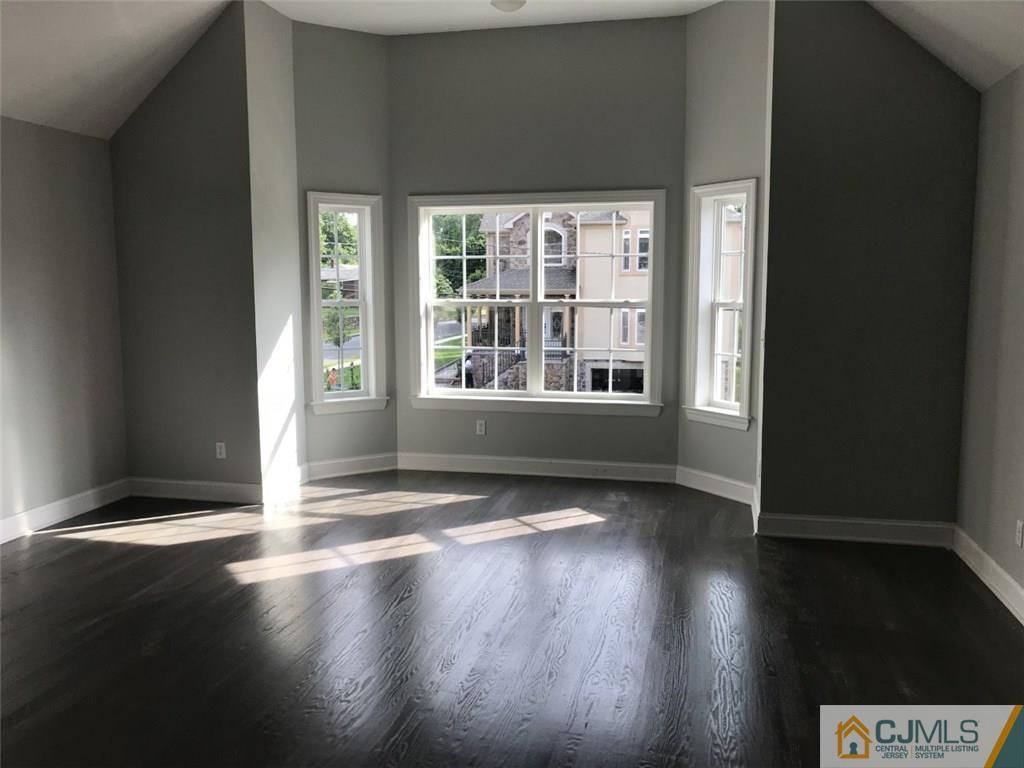 140 Dover Road Colonia, NJ 07067 - Photo 5 of 14 a view of an empty room with wooden floor and a window