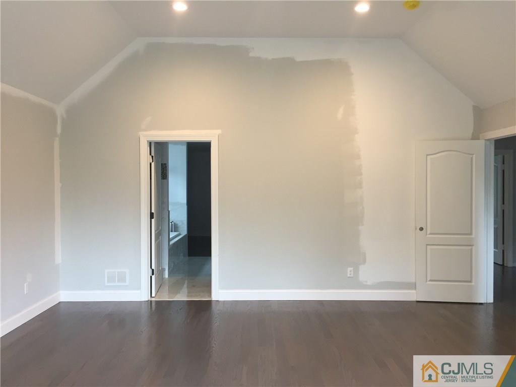 140 Dover Road Colonia, NJ 07067 - Photo 6 of 14 a view of an empty room with closet and wooden floor