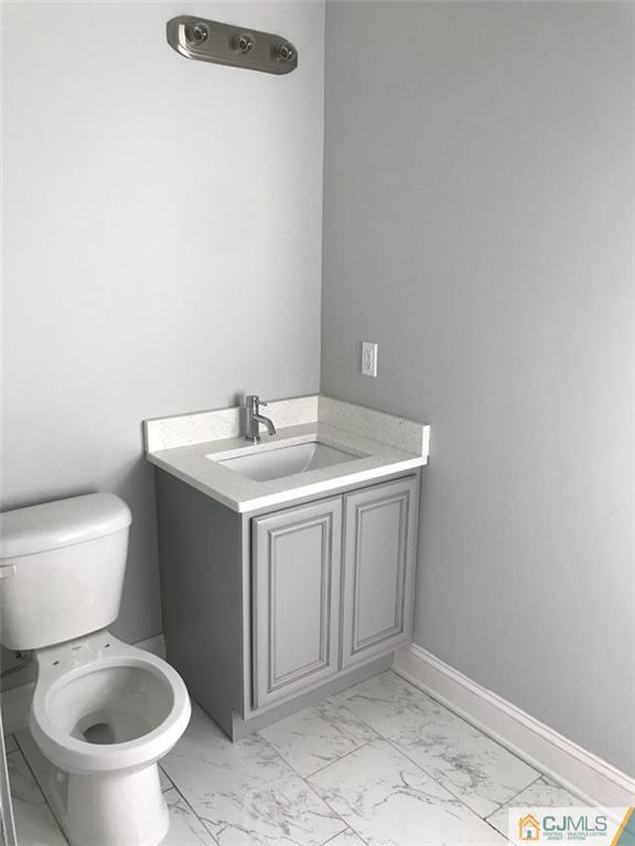 140 Dover Road Colonia, NJ 07067 - Photo 8 of 14 a bathroom with a sink a toilet and a mirror