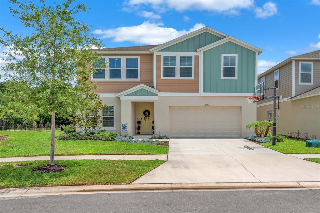 12952 Wellspring Drive Lithia, FL 33547 - Photo 1 of 46 a front view of a house with a yard and garage