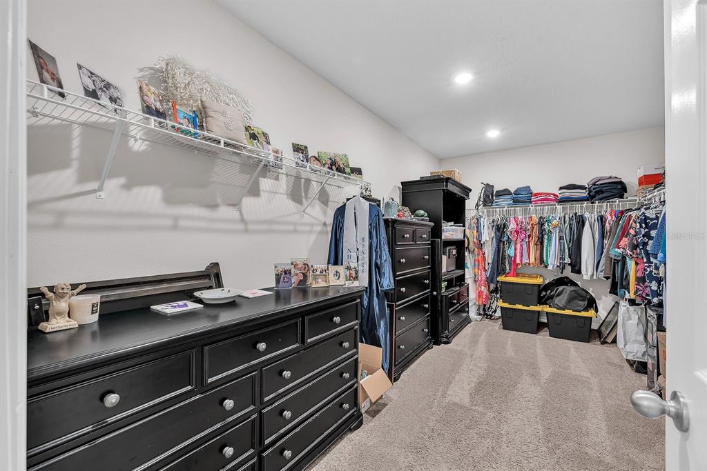 12952 Wellspring Drive Lithia, FL 33547 - Photo 19 of 46 a view of walk in closet with clothes and shoes