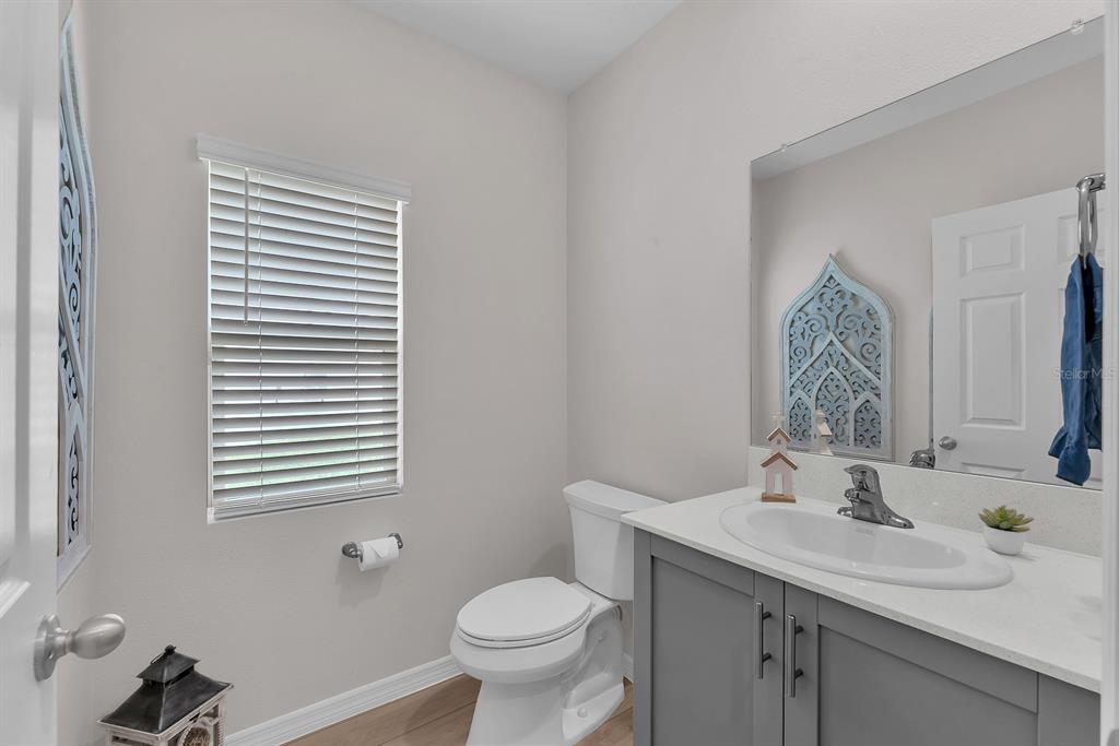 12952 Wellspring Drive Lithia, FL 33547 - Photo 20 of 46 a bathroom with a toilet sink and mirror