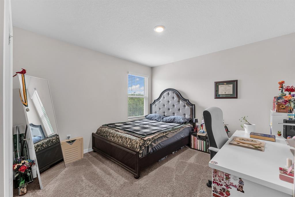 12952 Wellspring Drive Lithia, FL 33547 - Photo 29 of 46 a bedroom with furniture and a wooden floor