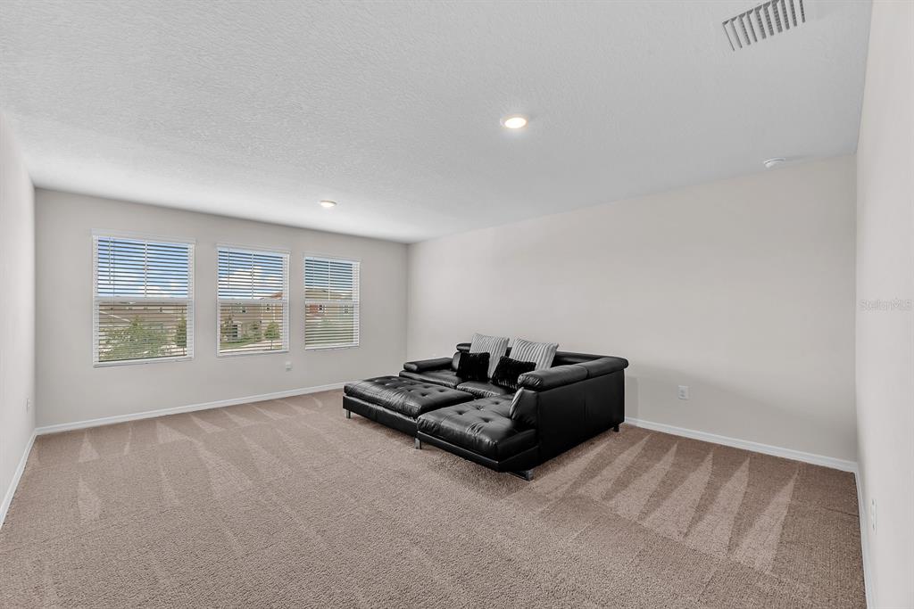 12952 Wellspring Drive Lithia, FL 33547 - Photo 31 of 46 a living room with furniture and a window