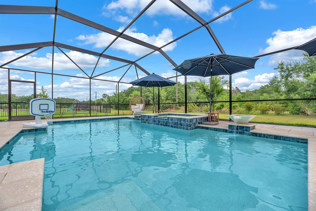 12952 Wellspring Drive Lithia, FL 33547 - Photo 34 of 46 a view of a backyard with a table and chairs under an umbrella