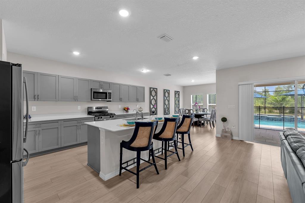 12952 Wellspring Drive Lithia, FL 33547 - Photo 6 of 46 a kitchen with appliances a sink a counter top space and cabinets