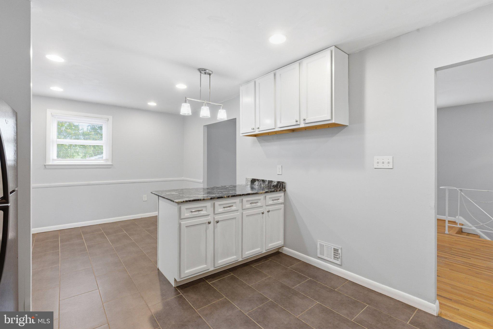 12908 Glynis Road Clinton, MD 20735 - Photo 11 of 32 a kitchen with stainless steel appliances granite countertop a sink and a stove