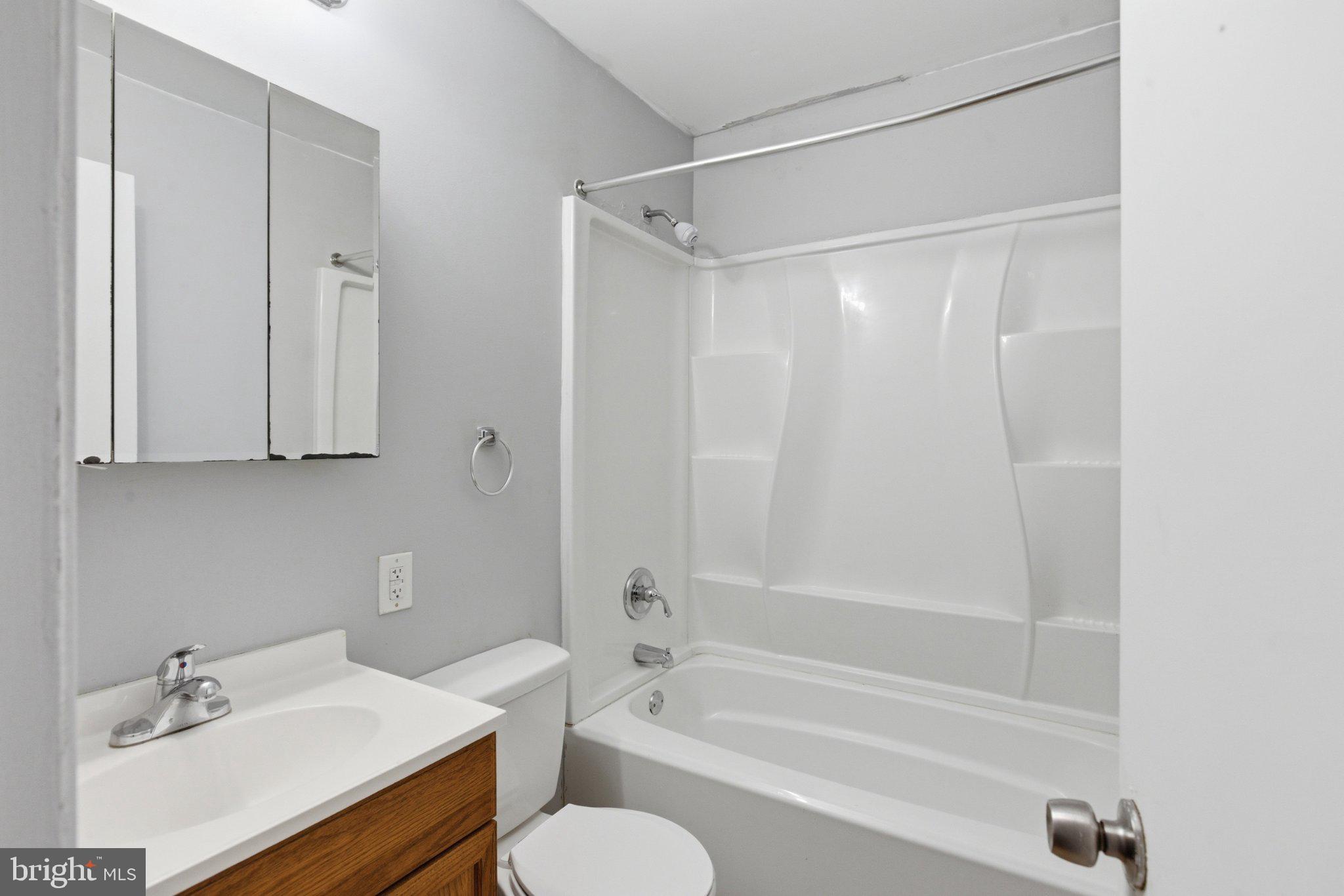 12908 Glynis Road Clinton, MD 20735 - Photo 15 of 32 a bathroom with a sink toilet and shower