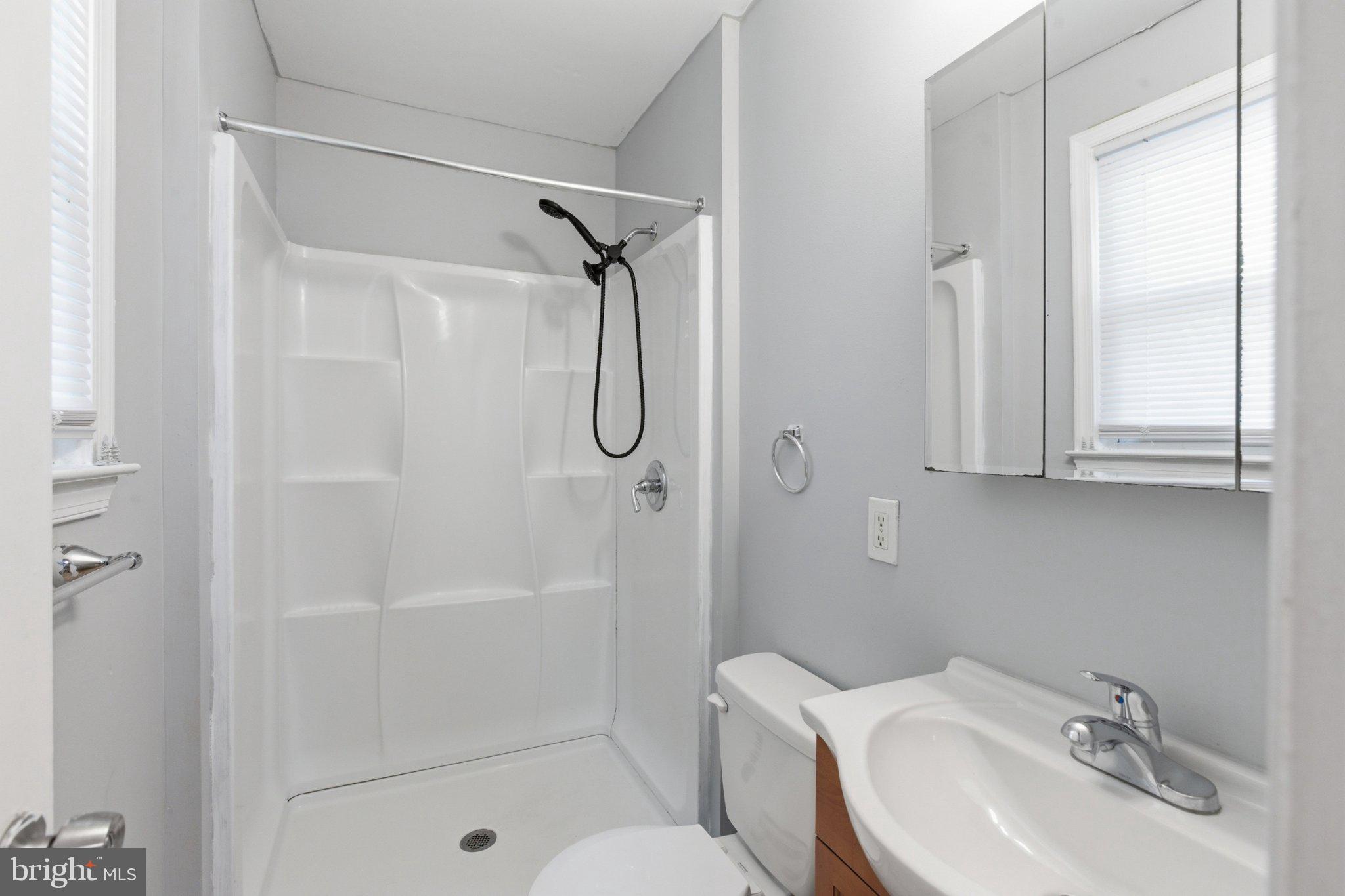 12908 Glynis Road Clinton, MD 20735 - Photo 16 of 32 a bathroom with a sink toilet and shower