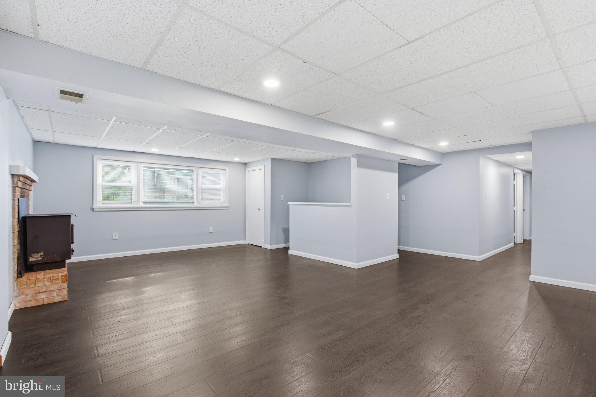 12908 Glynis Road Clinton, MD 20735 - Photo 18 of 32 a view of an empty room with a window and wooden floor