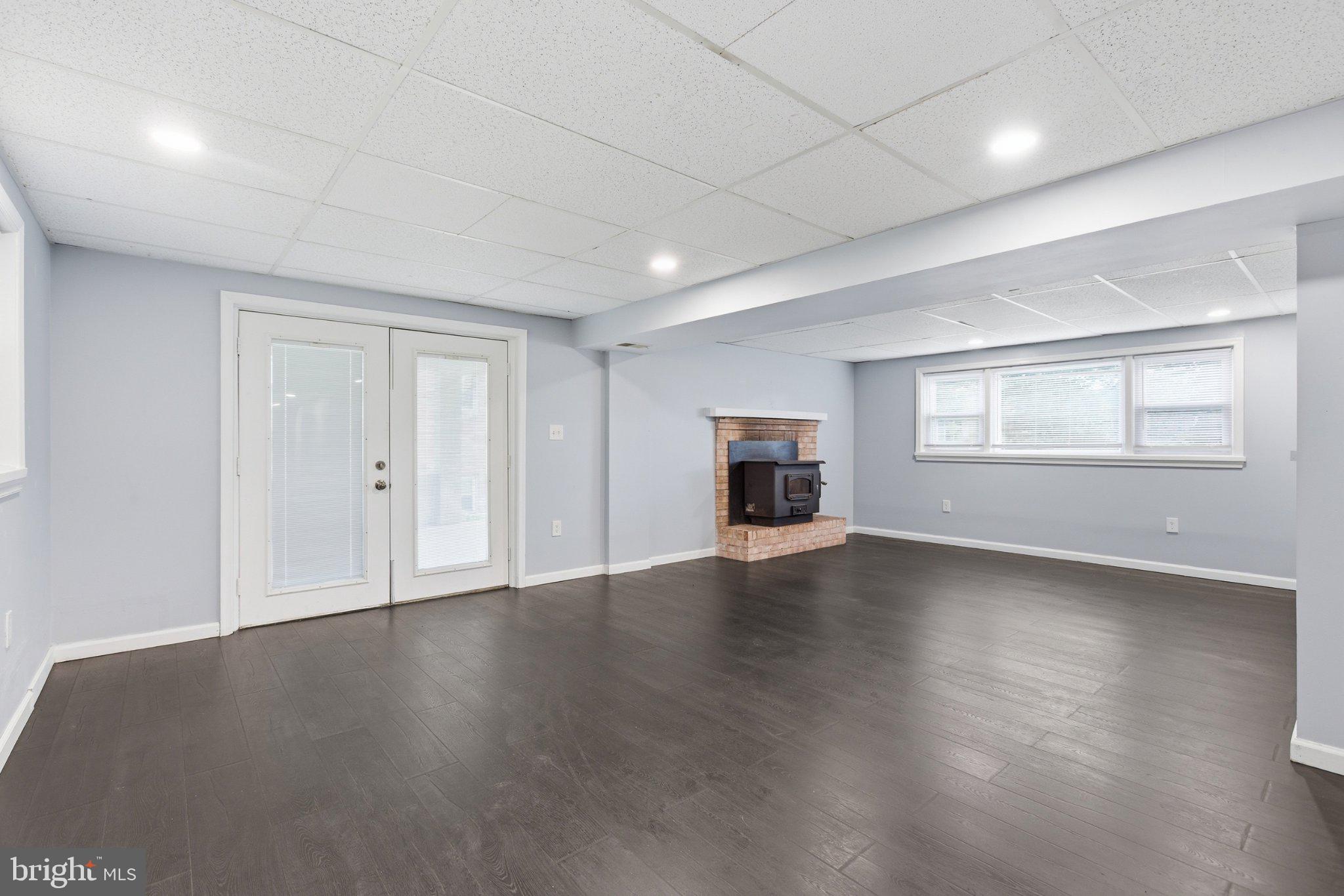 12908 Glynis Road Clinton, MD 20735 - Photo 20 of 32 an empty room with wooden floor and windows