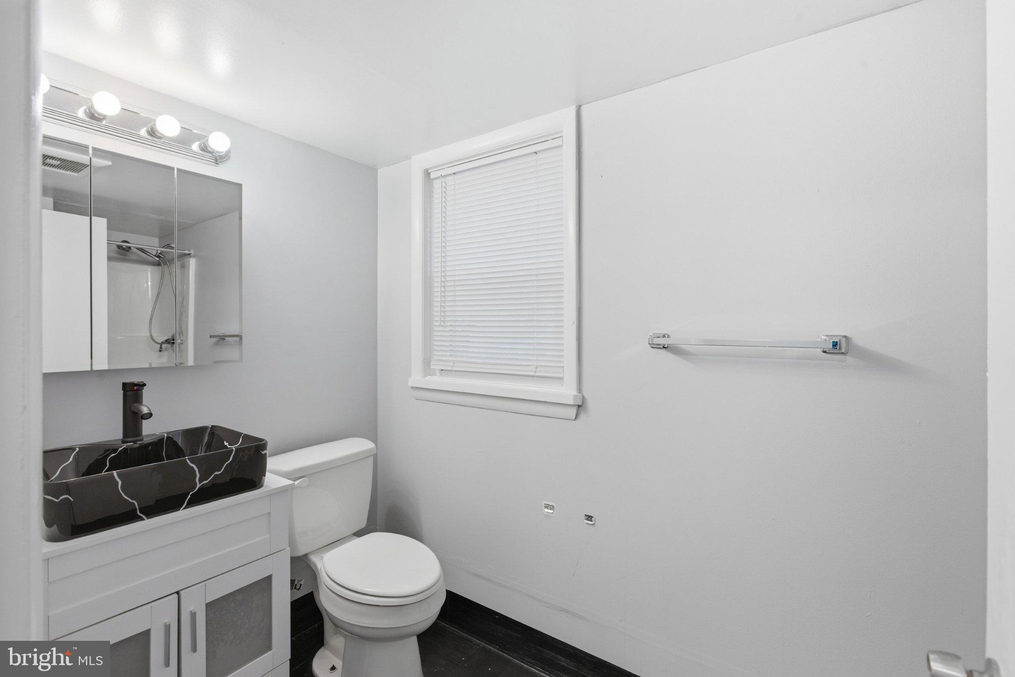 12908 Glynis Road Clinton, MD 20735 - Photo 24 of 32 a white toilet sitting next to a bathroom sink