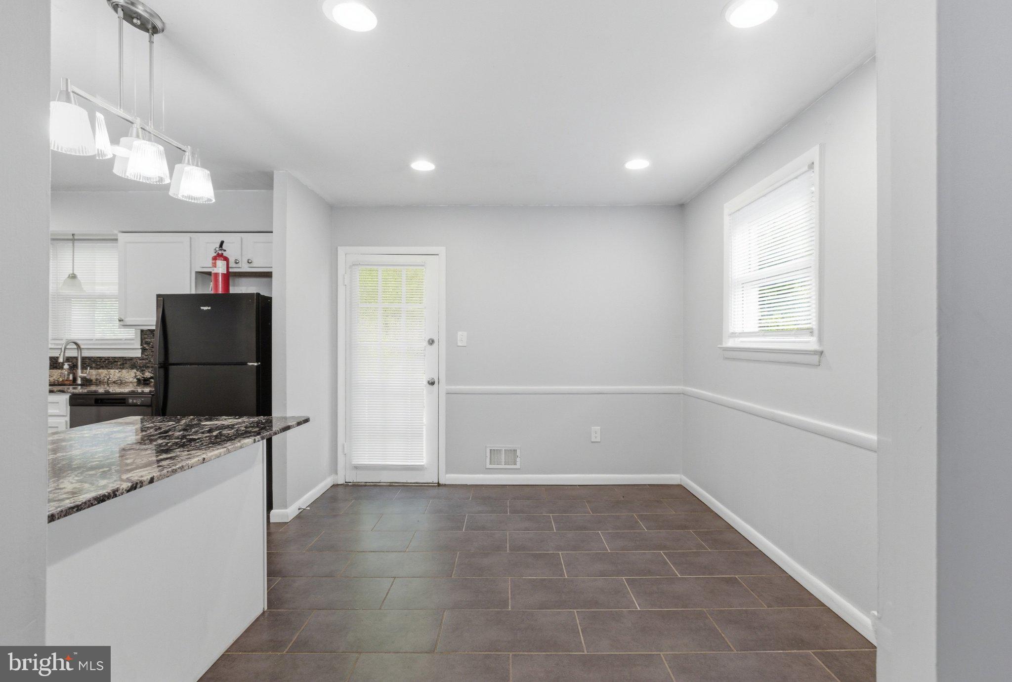 12908 Glynis Road Clinton, MD 20735 - Photo 6 of 32 a view of a kitchen with refrigerator and windows