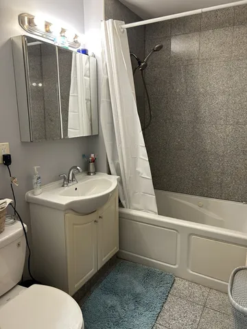 a bathroom with a sink toilet and shower