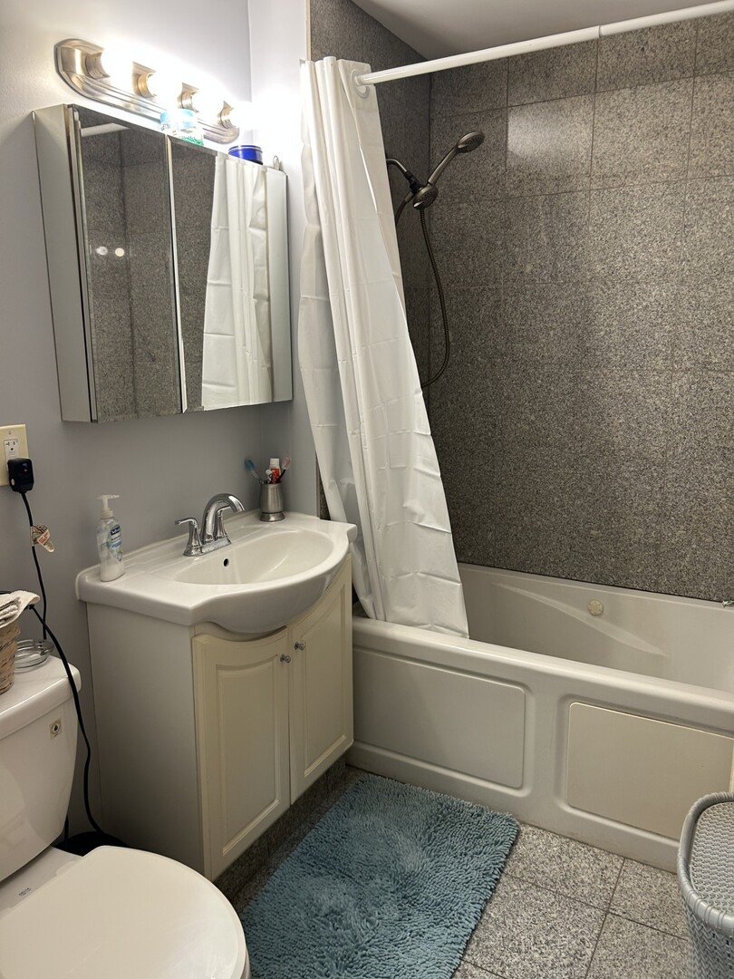 5107 West Cullom Avenue, Unit 2 Chicago, IL 60641 - Photo 15 of 22 a bathroom with a sink toilet and shower