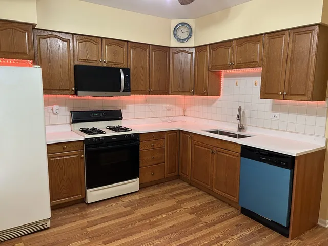 a kitchen with a sink cabinets and stainless steel appliances