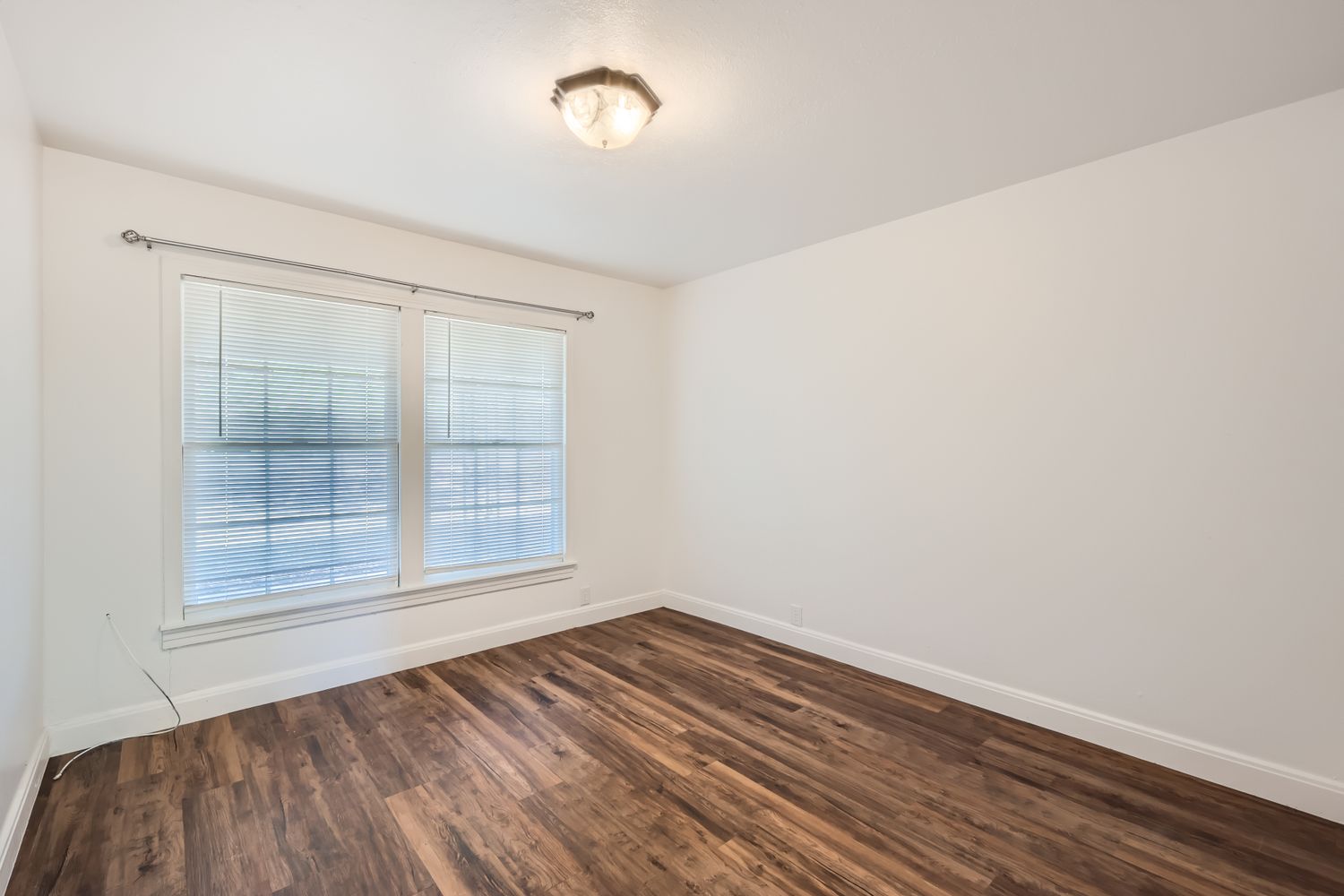 7348 Highway 183 Lockhart, TX 78644 - Photo 4 of 13 Empty room featuring baseboards and dark wood-style floors