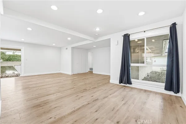 a kitchen with stainless steel appliances granite countertop a refrigerator a stove and a sink