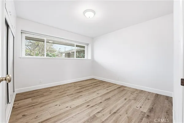an empty room with wooden floor