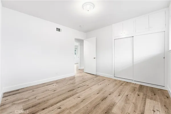 a spacious bathroom with a toilet sink and mirror
