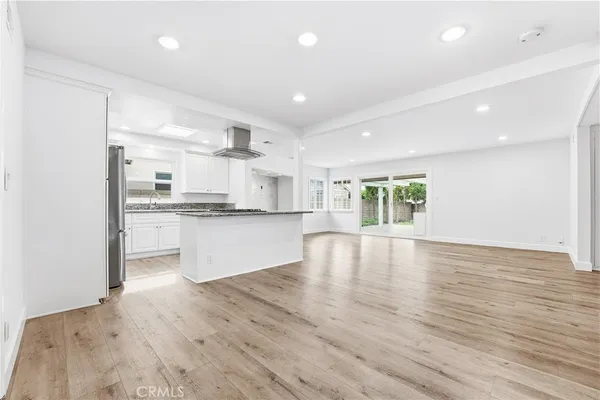 a open kitchen with white cabinets and fireplace