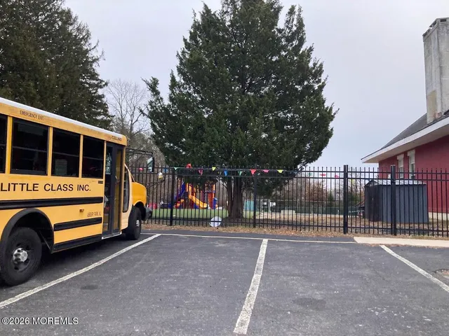 a view of outdoor space with deck and trees in the background