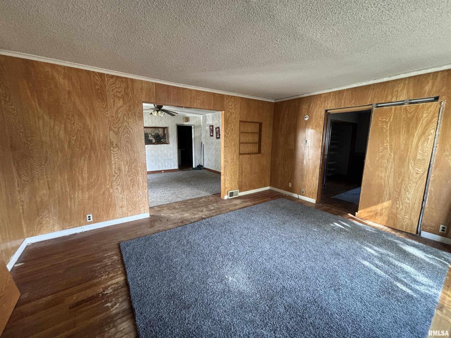 560 South 4th Street Clinton, IA 52732 - Photo 3 of 14 a view of empty room with wooden floor and cabinet