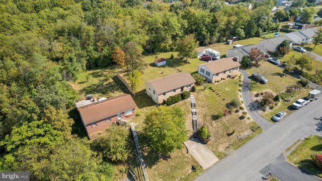 an aerial view of a house with a yard basket ball court and outdoor seating