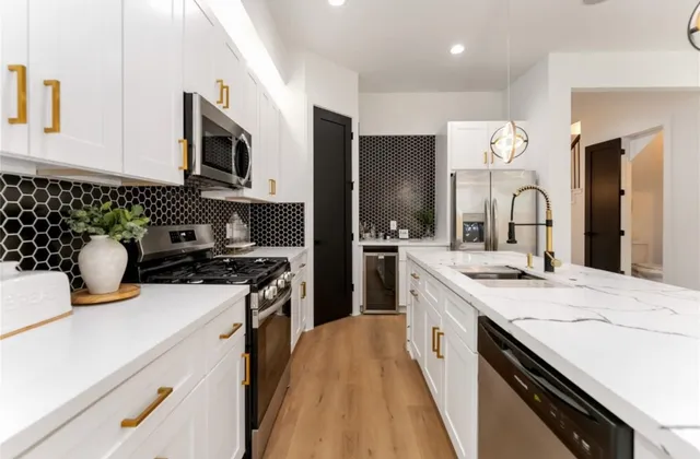 a kitchen with a sink stove and microwave