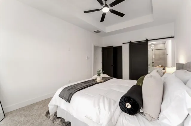 a bedroom with a bed and a chandelier