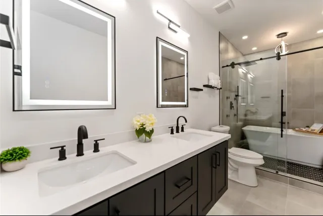 a bathroom with a sink double vanity and a toilet