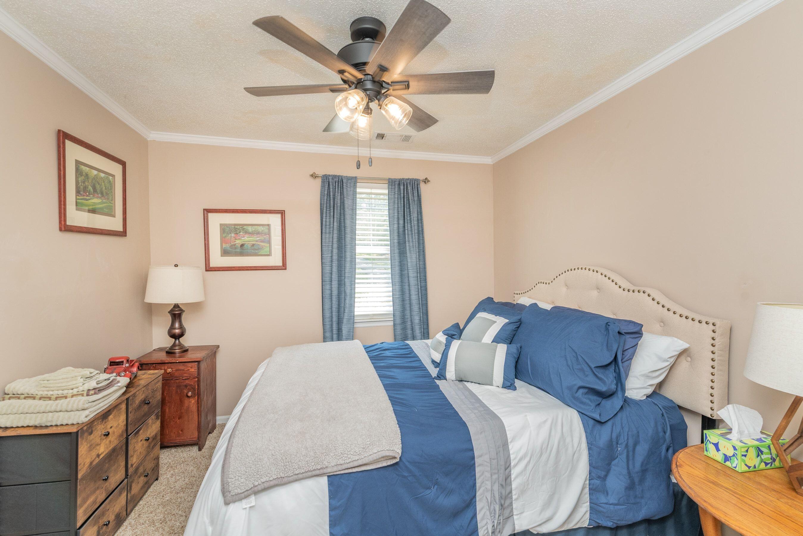 1117 Ridgemont Drive Aiken, SC 29803 - Photo 21 of 49 a bedroom with a bed and a chandelier
