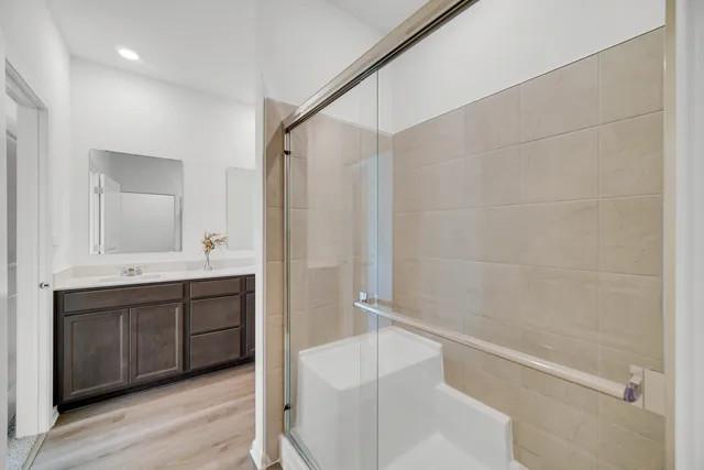 a bathroom with a tub a sink and mirror