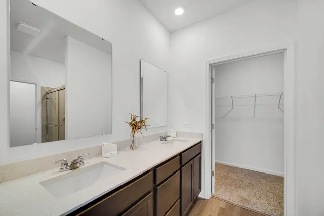 a bathroom with a sink double vanity and a mirror