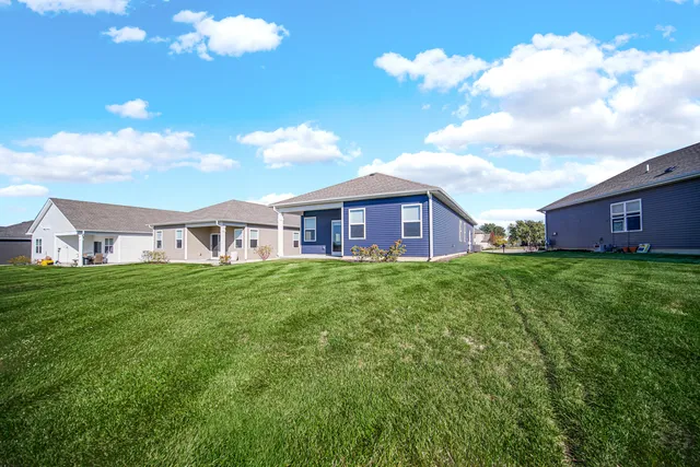 a view of a big yard with swimming pool and green space