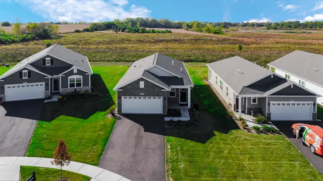 an aerial view of residential houses with outdoor space and street view